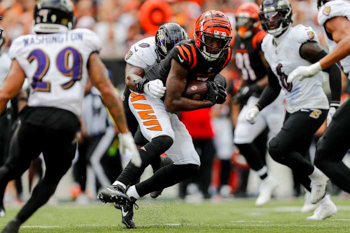 Sep 17, 2023; Cincinnati, Ohio, USA; Cincinnati Bengals wide receiver Tee Higgins (5) runs with the ball against Baltimore Ravens linebacker Roquan Smith (0) in the second half at Paycor Stadium. Mandatory Credit: Katie Stratman-USA TODAY Sports